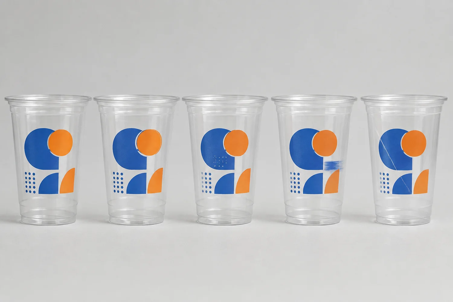 Printed plastic cup QC comparing approved print with registration shift, white halo, missing ink, smearing and scratches